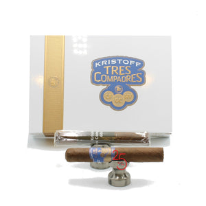 A box of Kristoff Tres Compadres cigars with individual cigars visible, packaged in plain green and blue wrappers with the original cigar band underneath.
