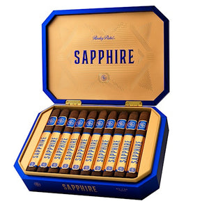 An open blue and gold cigar box containing ten cigars, shown on a plain white background. The box lid is open, displaying the brand name 'SAPPHIRE' in blue text on a gold interior, and the cigars are neatly arranged inside.