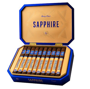 An open blue and gold cigar box containing ten cigars, shown on a plain white background. The box lid is open, displaying the brand name 'SAPPHIRE' in blue text on a gold interior, and the cigars are neatly arranged inside.