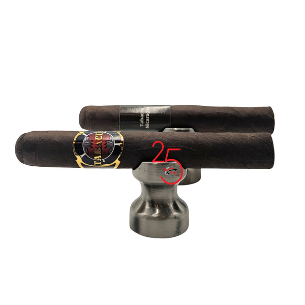 Two Tabacua Toro Gordo cigars with labels on a metal stand against a white background