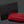 Red Siglo cigar case with black box featuring 'Siglo' brand on a dark background